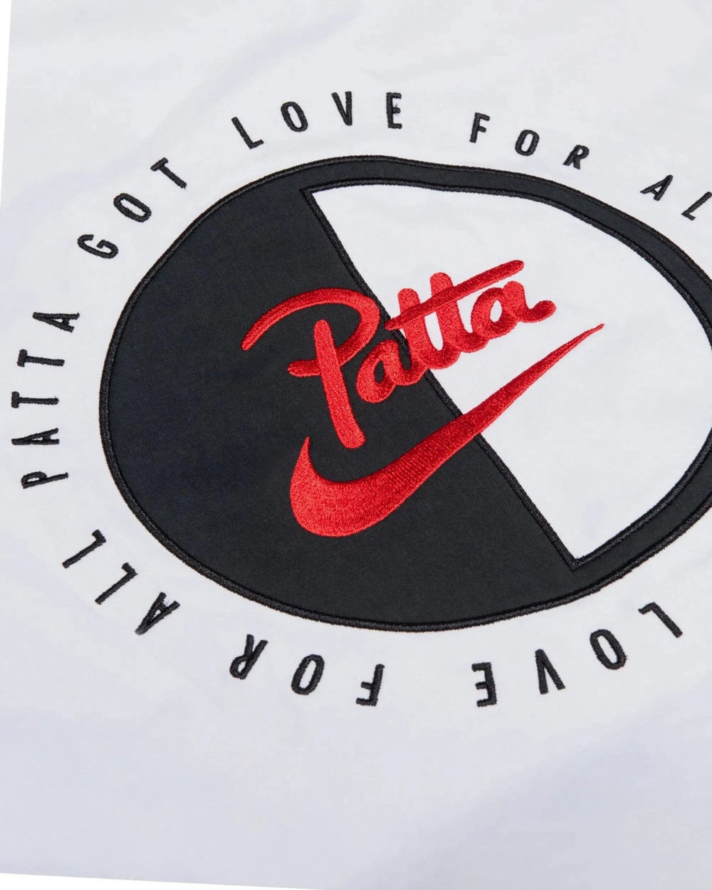 Embroidered red Patta x Nike back applique detail on the Deep Ocean and white NRG track jacket.